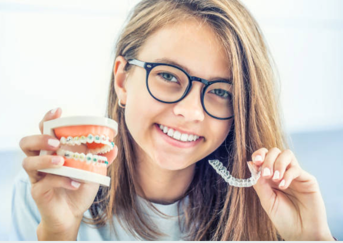 Image of a woman holding her orthodontic / Invisalign trays