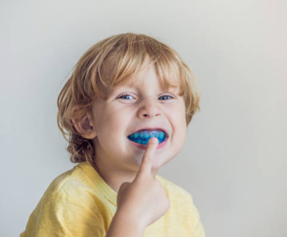 Image of a child with his mouthguard